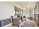 Relaxing sunroom with two chairs, a small side table, and tile flooring at 9625 E Center Ave # 5D, Denver, CO 80247