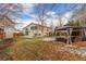 A spacious backyard includes a gazebo with outdoor seating, partial snow, leaves, and a basketball hoop at 4602 Genoa St, Denver, CO 80249