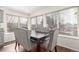Cozy dining area with large windows, hardwood floors, and elegant chairs at 4602 Genoa St, Denver, CO 80249
