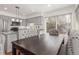 Cozy dining area with large windows, hardwood floors, and elegant chairs adjacent to kitchen at 4602 Genoa St, Denver, CO 80249