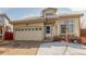 Inviting single-Gathering home featuring an attached two-car garage and a welcoming front entrance at 4602 Genoa St, Denver, CO 80249