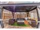 Gazebo with outdoor seating and overhead lighting in a landscaped backyard at 4602 Genoa St, Denver, CO 80249