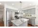 Beautiful kitchen with stainless steel appliances, gray cabinets, and granite countertops at 4602 Genoa St, Denver, CO 80249