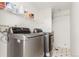 Laundry room featuring modern washer and dryer on tile flooring at 4602 Genoa St, Denver, CO 80249