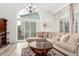 Bright living room with high ceilings, a sliding glass door, and hardwood floors at 4602 Genoa St, Denver, CO 80249