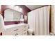Stylish bathroom showcasing a white vanity, floral wallpaper, and a modern shower with a white curtain at 982 E 130Th Cir, Thornton, CO 80241