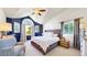 Bright bedroom with a vaulted ceiling, large windows, a king size bed, and stylish furnishings for a cozy retreat at 982 E 130Th Cir, Thornton, CO 80241