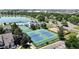An aerial view of community amenities: a lake, pool, tennis courts, and a sand volleyball court at 982 E 130Th Cir, Thornton, CO 80241