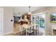 Dining area showcases light wood flooring, an adjacent kitchen, and sliding door access to yard at 982 E 130Th Cir, Thornton, CO 80241