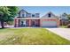Charming two-story home with a brick facade, covered porch and a well-manicured lawn at 982 E 130Th Cir, Thornton, CO 80241