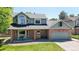 Charming two-story home with a well-manicured lawn and a cozy front porch seating area at 982 E 130Th Cir, Thornton, CO 80241