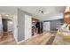 Open kitchen with stainless steel appliances, light wood floors, granite countertops, and access to the adjacent hallway at 982 E 130Th Cir, Thornton, CO 80241