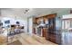 Open kitchen with stainless steel appliances, granite counters, light wood floors, and an adjacent dining area and living space at 982 E 130Th Cir, Thornton, CO 80241