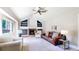 Bright living room features a cozy fireplace, built-in shelves, and a large window at 982 E 130Th Cir, Thornton, CO 80241
