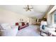 Bright living room includes an open layout with a ceiling fan and view of dining area at 982 E 130Th Cir, Thornton, CO 80241