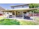 Covered patio with outdoor dining and seating, ceiling fans, and string lights at 982 E 130Th Cir, Thornton, CO 80241