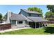 Spacious backyard with covered patio, mature trees, and lush green grass at 982 E 130Th Cir, Thornton, CO 80241