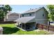 Spacious backyard with covered patio, mature trees, and lush green grass at 982 E 130Th Cir, Thornton, CO 80241