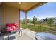 Covered back porch with outdoor furniture overlooking a grassy backyard and a wood fence at 9679 Waco St, Commerce City, CO 80022