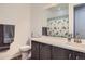 Bathroom features a vanity with solid surface countertops, wood-look flooring, and a turtle-themed shower curtain at 9679 Waco St, Commerce City, CO 80022