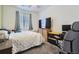 Bedroom features neutral-toned walls and carpet, a ceiling fan, and a large window with blinds and curtains at 9679 Waco St, Commerce City, CO 80022