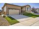 Inviting home exterior with a two-car garage and a well-maintained lawn at 9679 Waco St, Commerce City, CO 80022