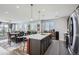 Modern kitchen featuring stainless steel appliances, a large island, and open dining area with lots of natural light at 9679 Waco St, Commerce City, CO 80022