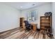 Bright home office space with a wooden desk, natural light, and shelving for an efficient workspace at 9679 Waco St, Commerce City, CO 80022