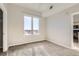 Bright bedroom featuring neutral paint, plush carpeting, and a large window showcasing the city view at 15475 Andrews Dr # 401, Denver, CO 80239
