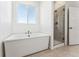 Bright bathroom with a modern soaking tub and glass enclosed shower at 3639 Recess Ln, Castle Rock, CO 80108