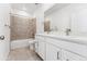 Modern bathroom with dual sinks, white cabinets, and a tiled shower/tub at 3639 Recess Ln, Castle Rock, CO 80108