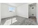 An airy bedroom features plush carpet, a large window, and neutral walls at 3639 Recess Ln, Castle Rock, CO 80108