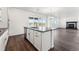 Kitchen island with stainless steel sink and appliances overlooking the living room and fireplace at 3639 Recess Ln, Castle Rock, CO 80108