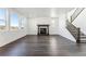Bright living room featuring a fireplace, staircase and ample natural light from large windows at 3639 Recess Ln, Castle Rock, CO 80108