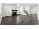 Bright and open living space showcasing fireplace, stairs, and natural light at 3639 Recess Ln, Castle Rock, CO 80108