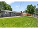 Expansive backyard featuring lush green lawn, mature trees, and a patio for outdoor entertaining at 602 Birch St, Broomfield, CO 80020