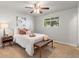 Bright bedroom with soft carpet, decorative pillows, a window view, and a stylish modern bench at 602 Birch St, Broomfield, CO 80020