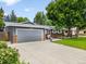 Spacious driveway leading to a two-car garage, complemented by well-maintained landscaping at 602 Birch St, Broomfield, CO 80020