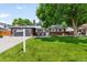 Charming home with lush front lawn, mature trees, and inviting curb appeal at 602 Birch St, Broomfield, CO 80020