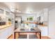 Modern kitchen with stainless steel appliances, bright lighting, and breakfast bar with seating at 602 Birch St, Broomfield, CO 80020
