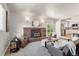Spacious living room with fireplace, comfortable seating, and seamless access to the kitchen and outdoor space at 602 Birch St, Broomfield, CO 80020