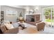 Cozy living room features a brick fireplace, comfortable seating, and a sliding door to the backyard at 602 Birch St, Broomfield, CO 80020