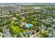 Expansive aerial shot showcases a residential neighborhood with a community pool and numerous trees at 8189 E 29Th Ave, Denver, CO 80238
