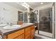 Bathroom featuring dual sinks and tile shower with glass door at 8189 E 29Th Ave, Denver, CO 80238