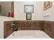 Relaxing bathroom with a soaking tub and custom tile surround at 8189 E 29Th Ave, Denver, CO 80238