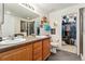 Bathroom featuring a double vanity, walk-in shower, and open closet at 8189 E 29Th Ave, Denver, CO 80238