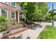 Charming brick home exterior featuring a well-manicured yard, wrought iron fence, and inviting front porch at 8189 E 29Th Ave, Denver, CO 80238