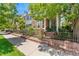 Attractive multi-story home with brick and siding, accented by a decorative metal fence and landscaped front yard at 8189 E 29Th Ave, Denver, CO 80238