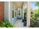 Cozy front porch with blue siding, potted plants, and charming decorative details at 8189 E 29Th Ave, Denver, CO 80238
