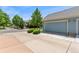 Spacious two-car garage with a long driveway and neatly trimmed shrubs at 8189 E 29Th Ave, Denver, CO 80238